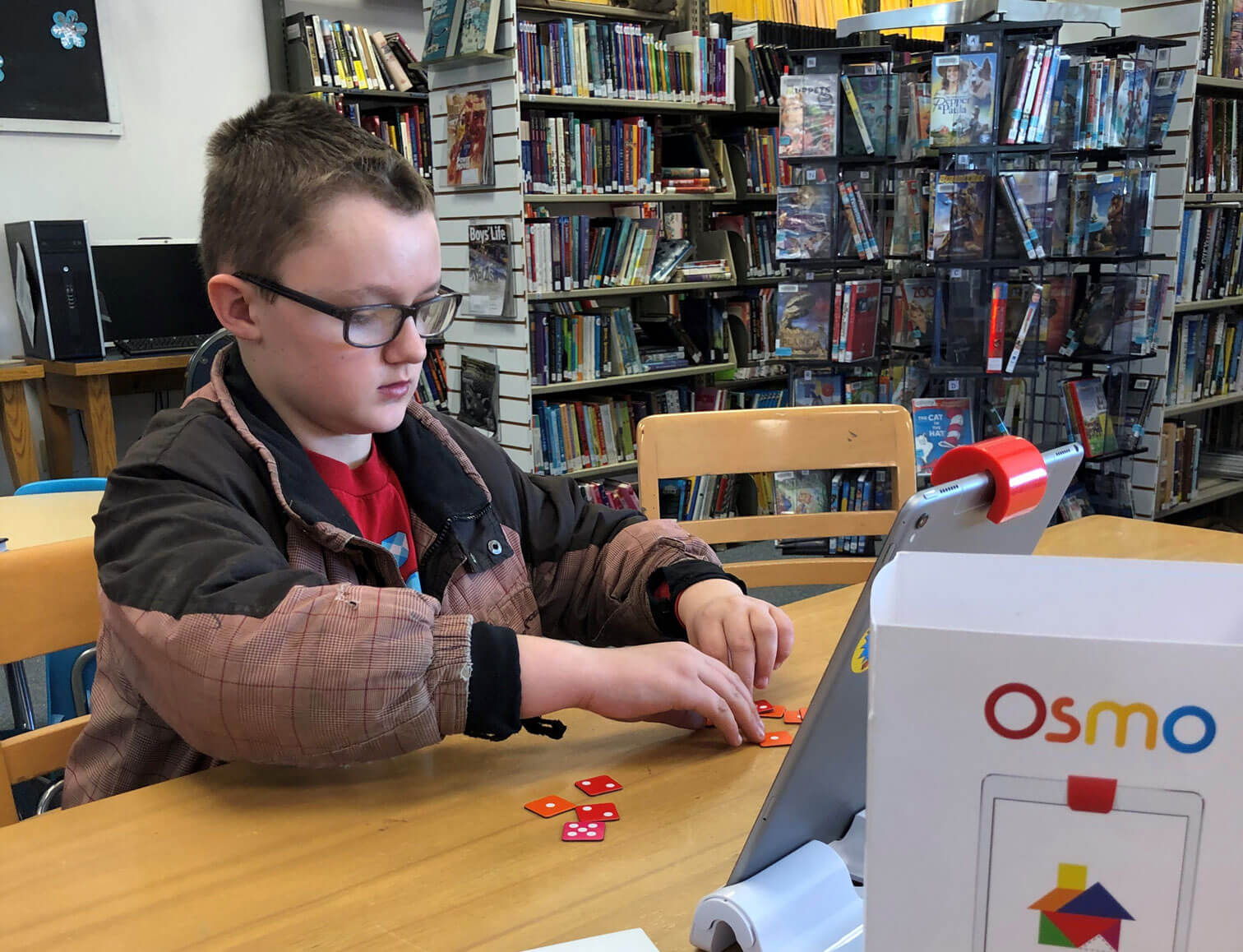Child working at a table in Whitewood Public Library